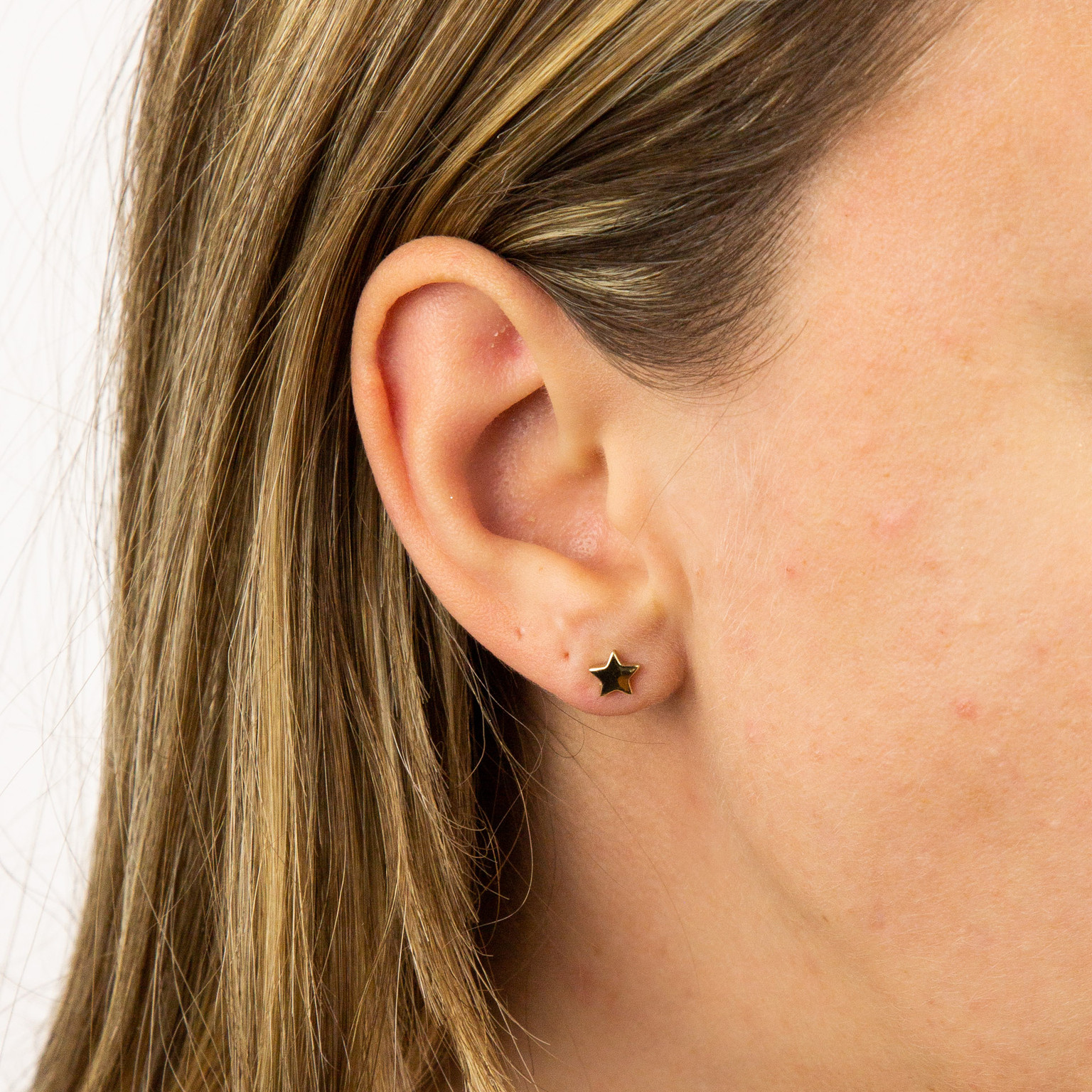 9ct yellow gold stud earrings, worn
