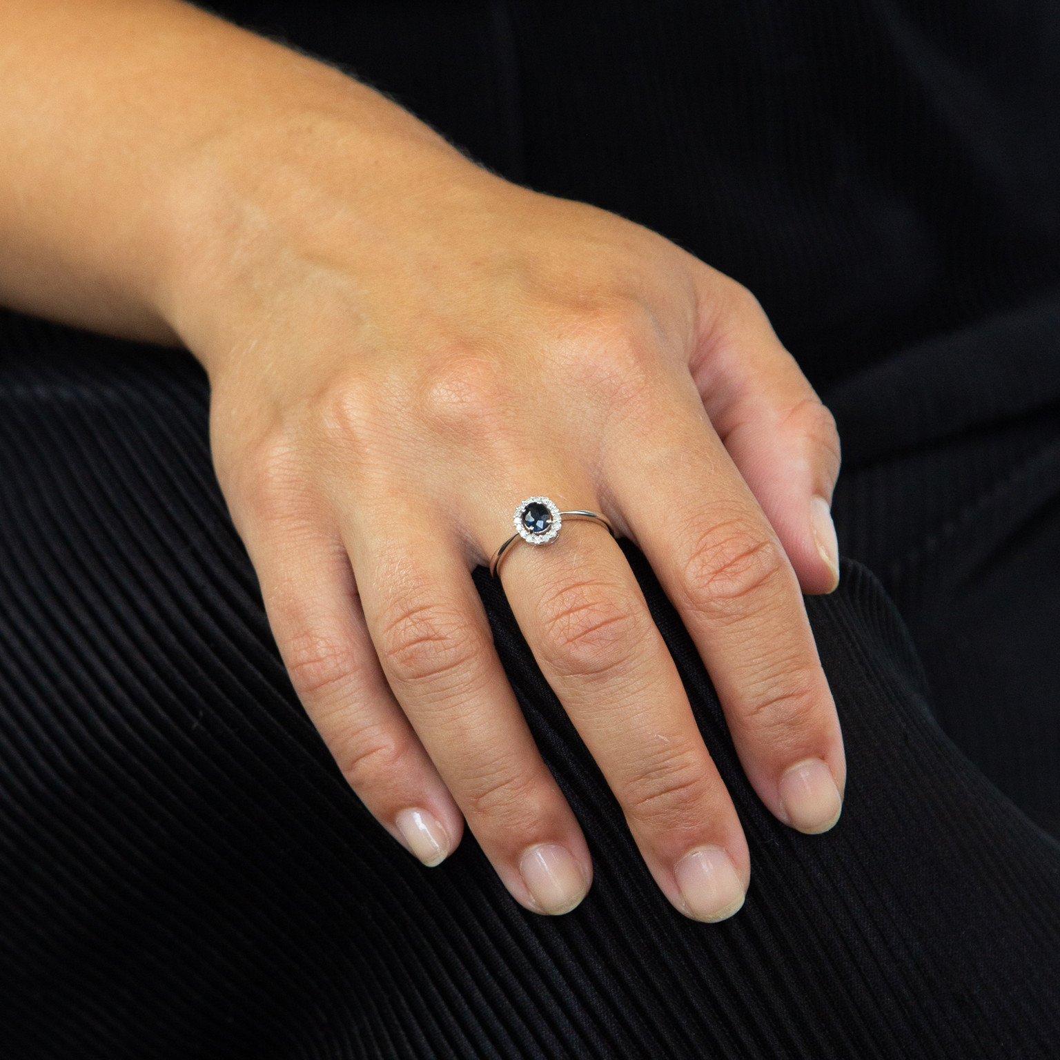 9ct white gold ring with blue sapphire and diamonds, worn